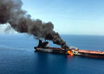 A fire broke out on an oil supertanker in the Strait of Hormuz after it struck a naval mine.