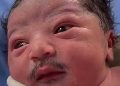 Video of a newborn with a mustache goes viral on social media; users share amusing comments.